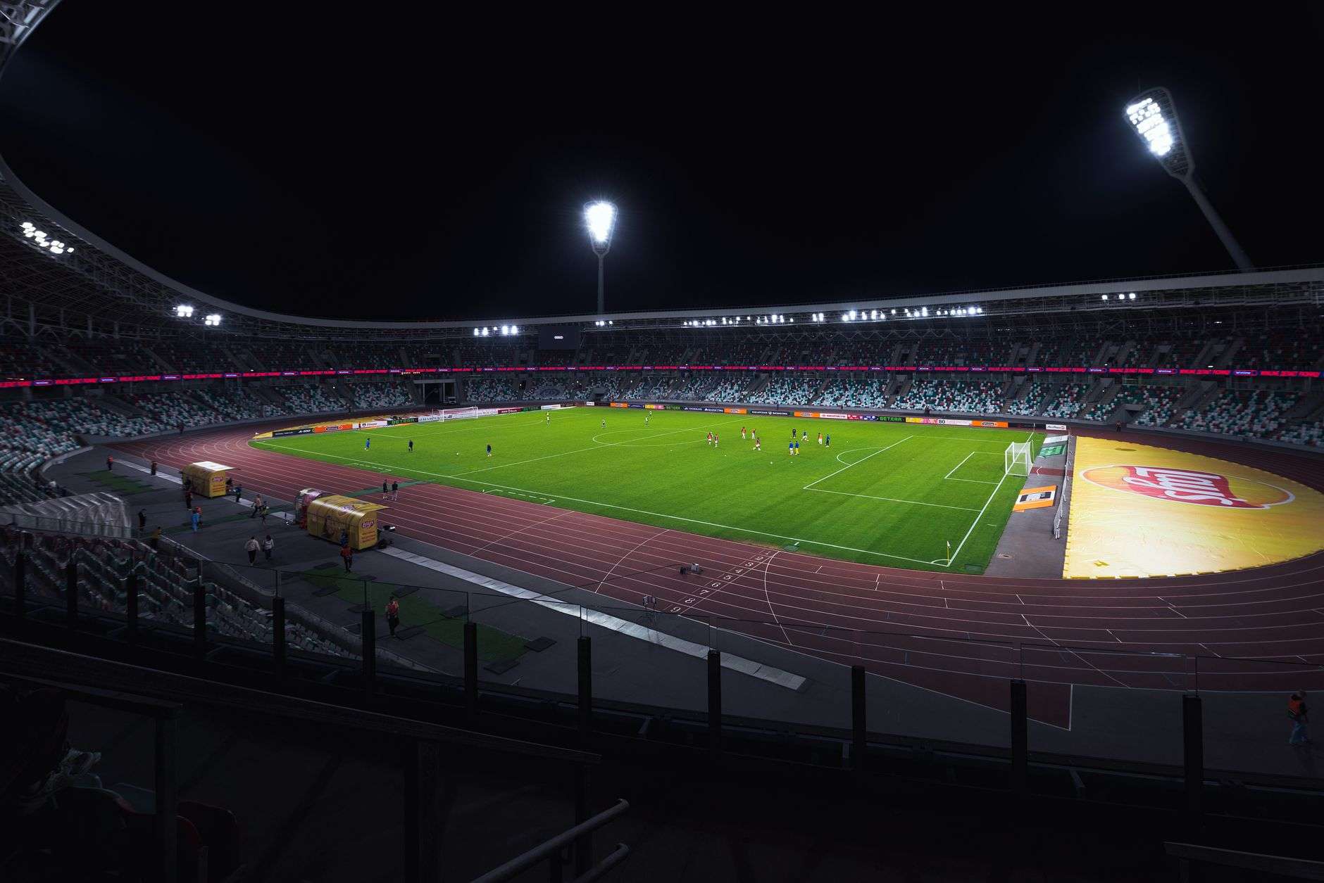Illuminated football scoreboard at a stadium