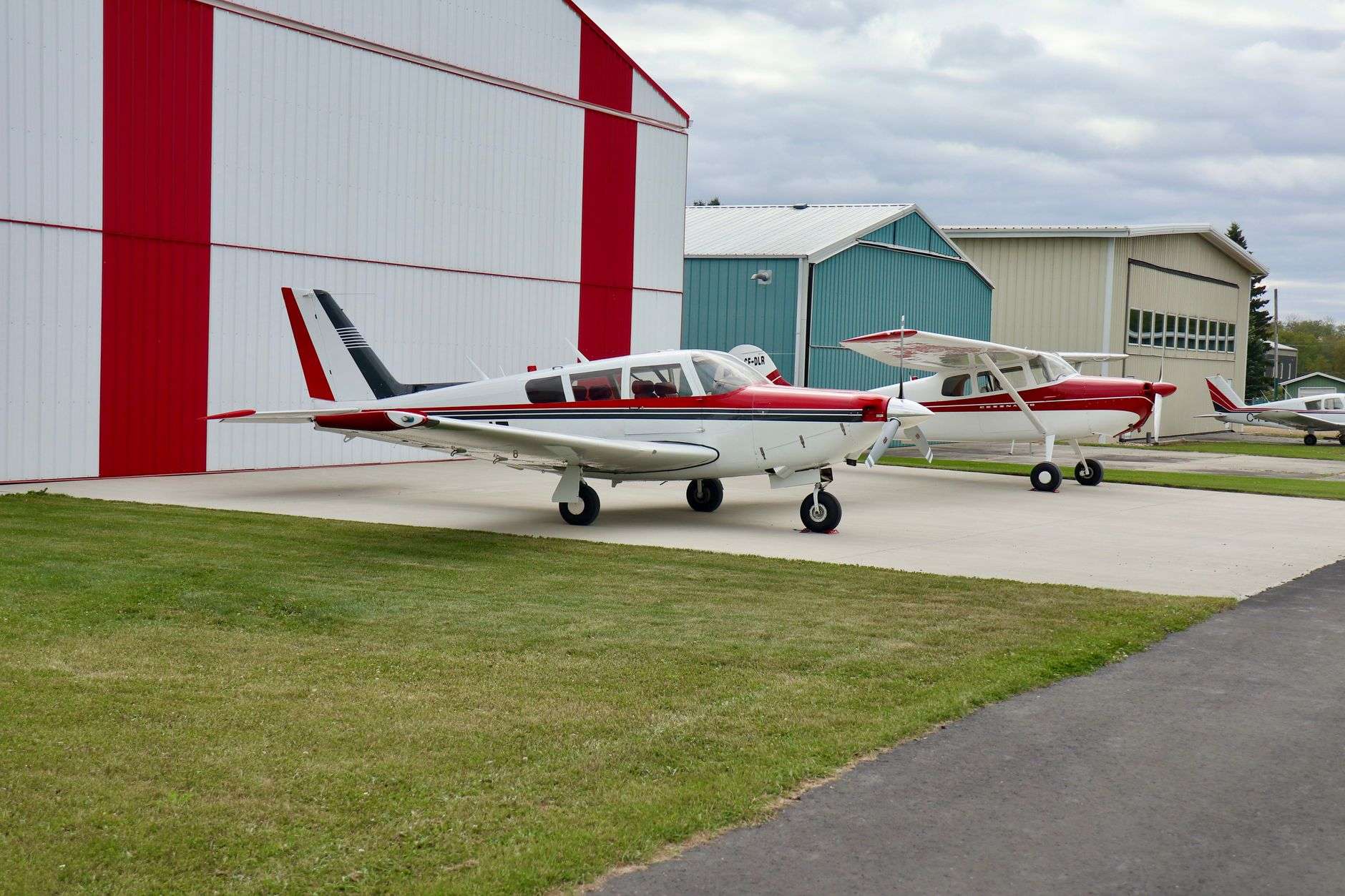 Small aircraft parked on a paved apron at a general aviation airport