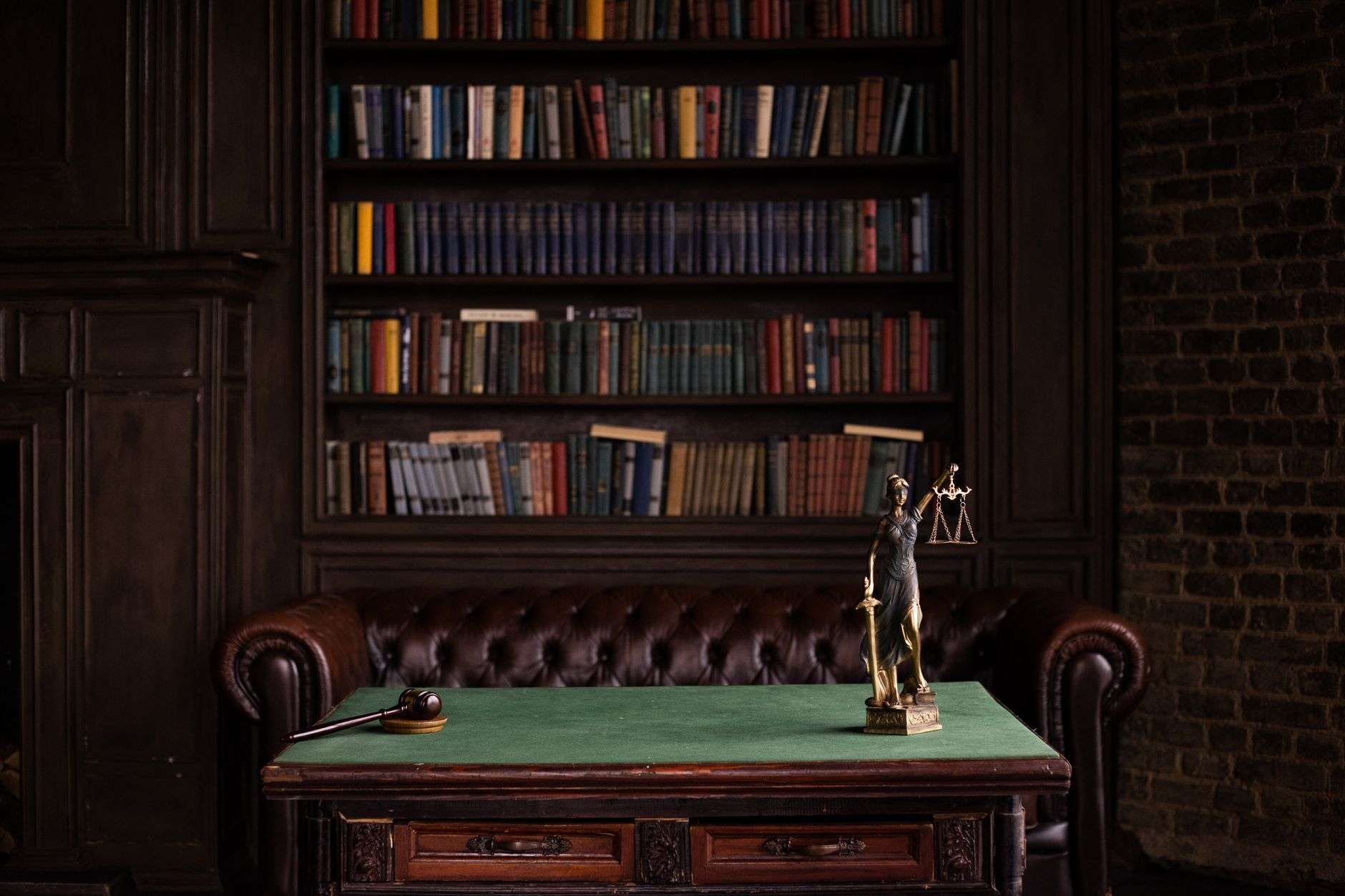 A wooden gavel resting on a bench in a courtroom