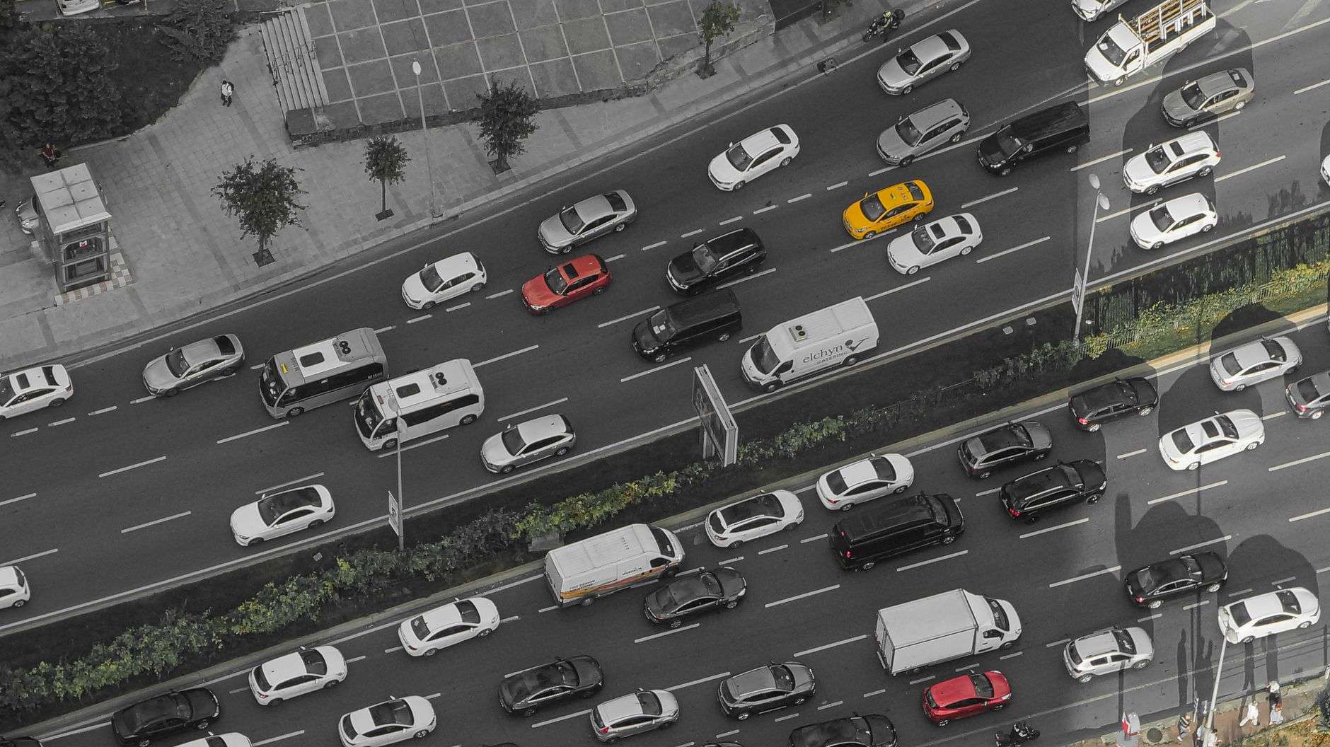 Bumper to bumper traffic filling multiple lanes of a highway on a clear day