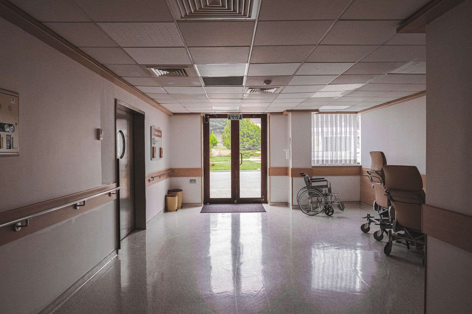 A clinician's stethoscope and medical equipment in an examination room