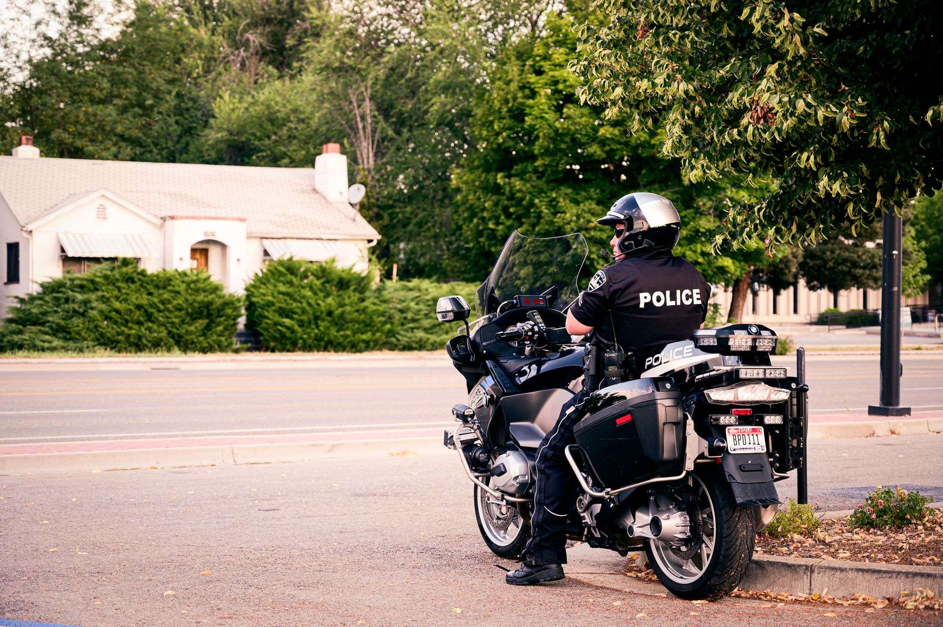 Police motorcycle with emergency lights parked on pavement