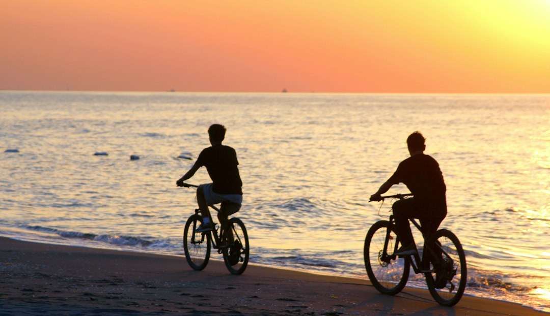 Group of cyclists riding along a coastal road during a charity bike ride