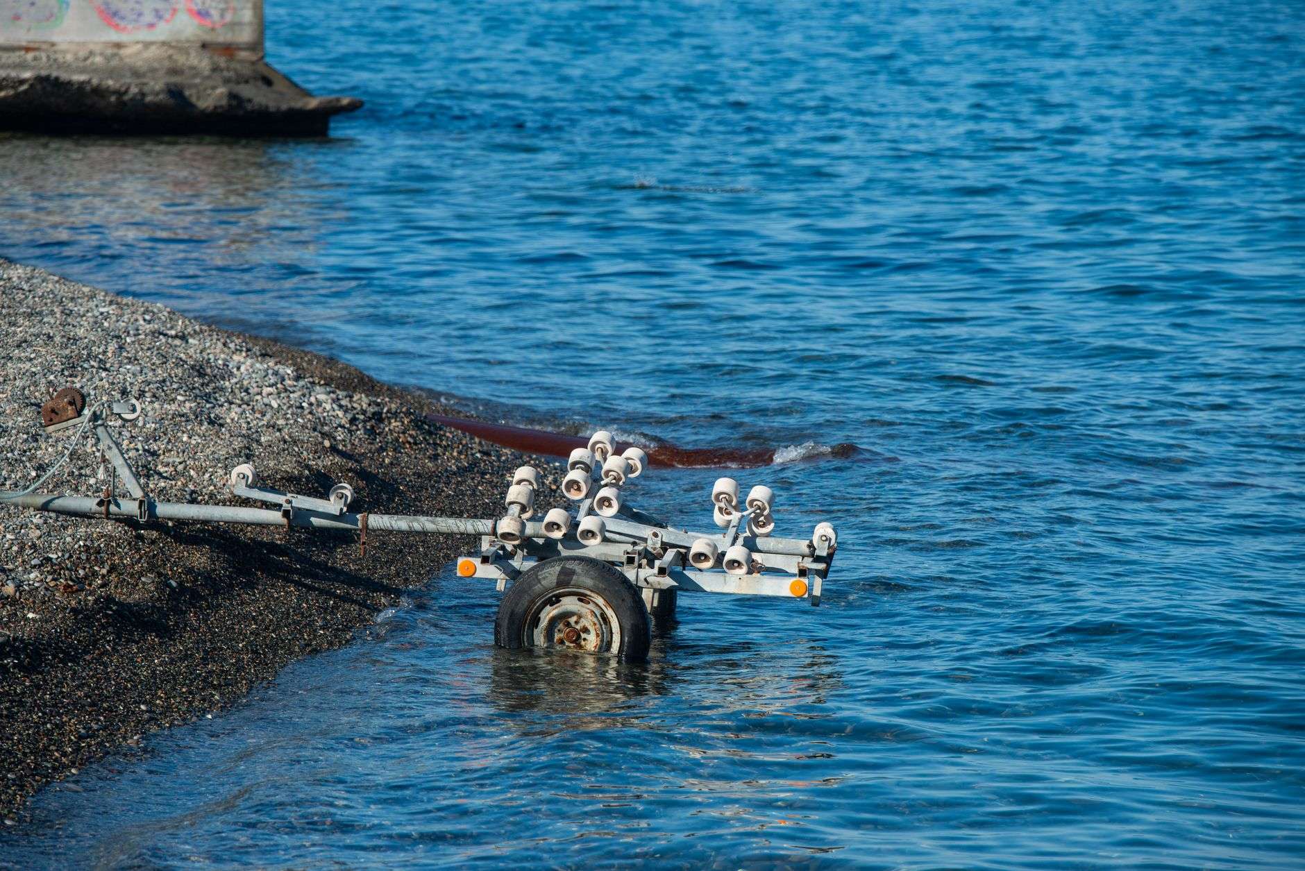 A public boat launch ramp leading into coastal water