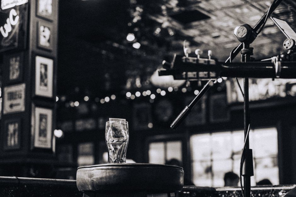 Small music venue with a stage, bar and seating in a cozy room