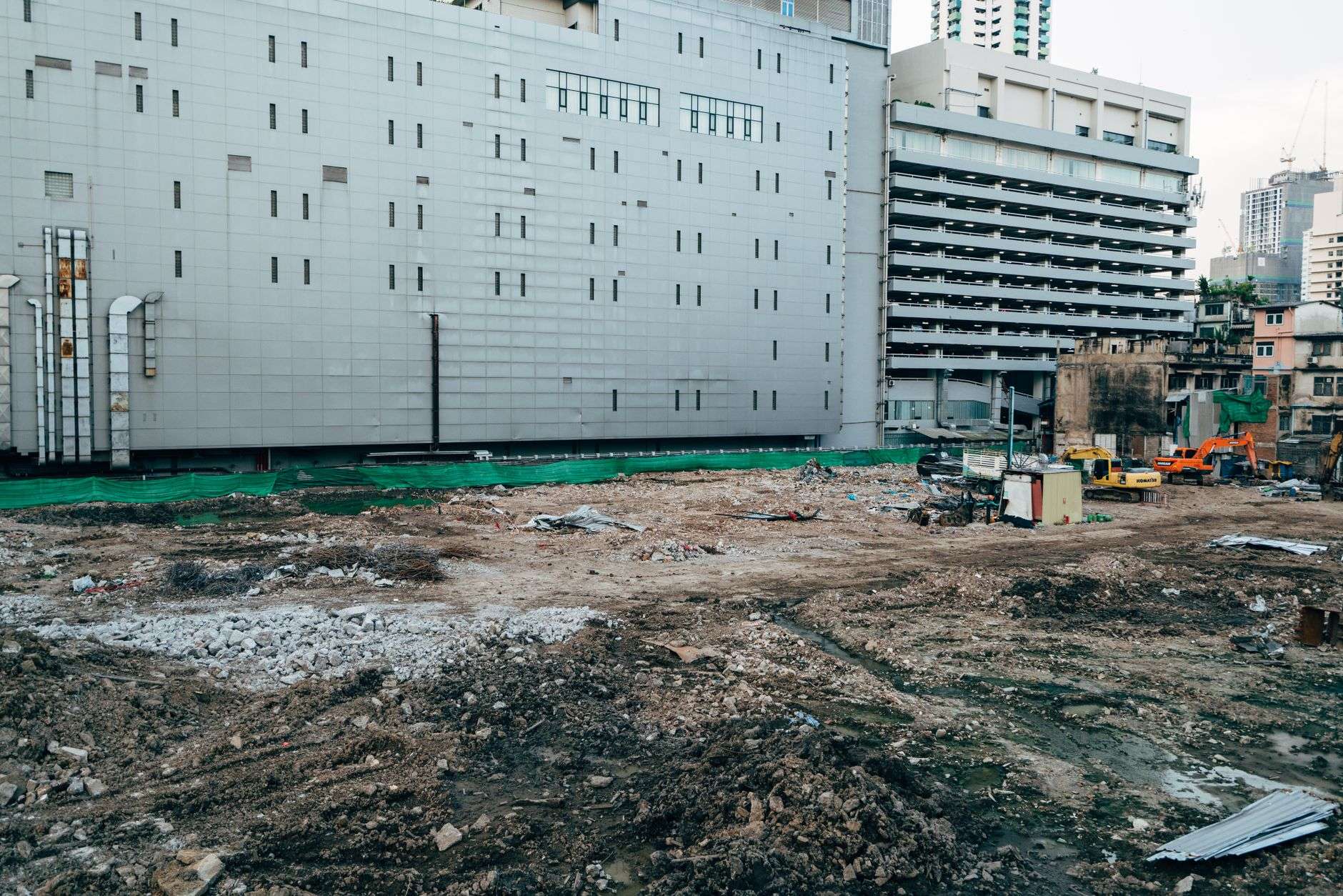 Long-reach excavator demolishing a multi-story building