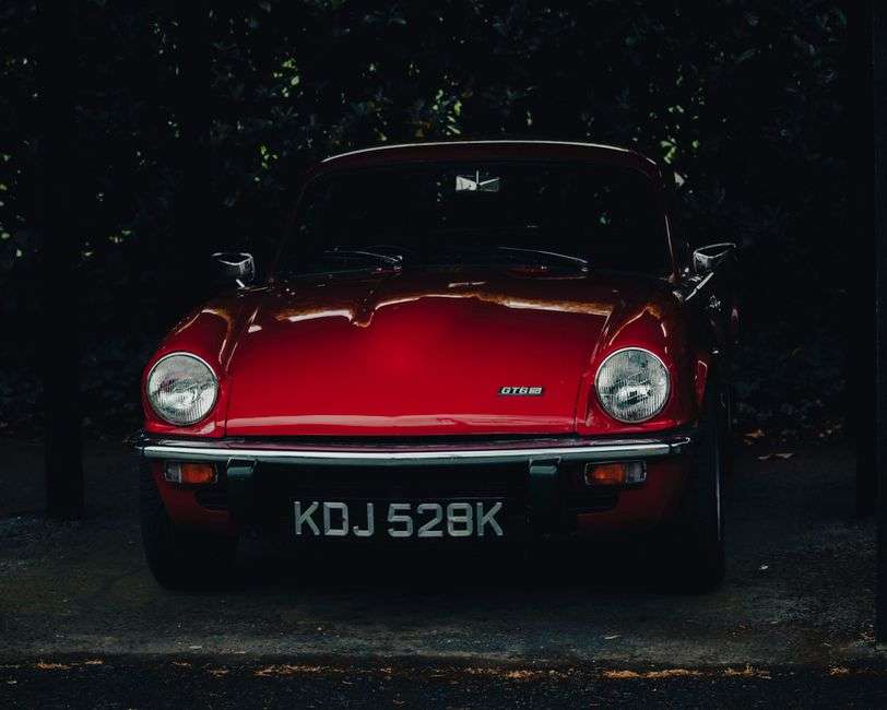 A restored classic British sports car parked on a show field