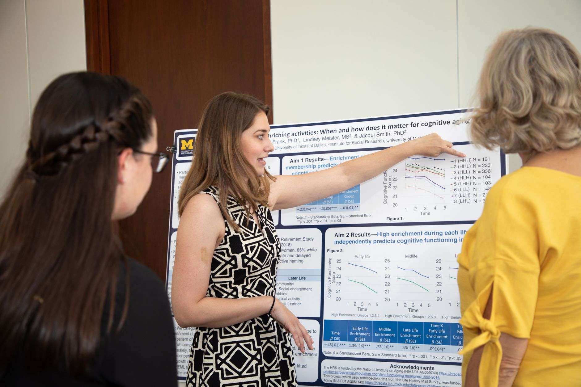 Researcher presenting a poster at a medical conference