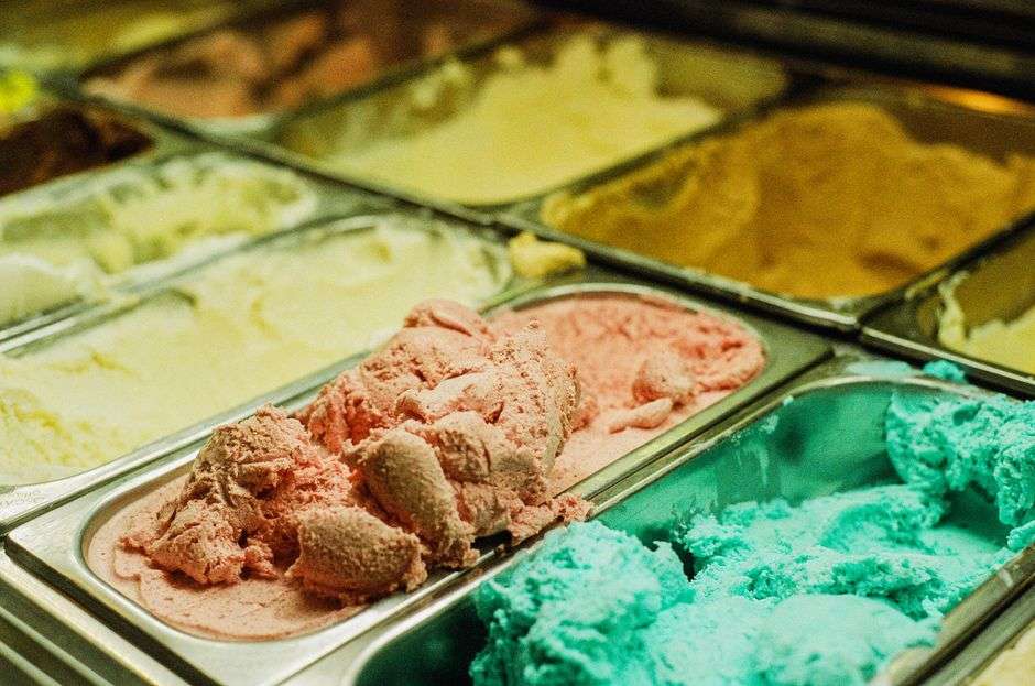 Scoops of homemade ice cream served at a classic ice cream shop counter
