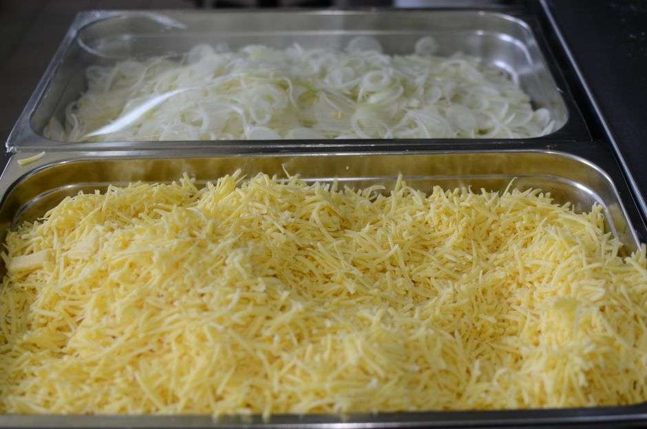 A catering kitchen with trays of prepared food