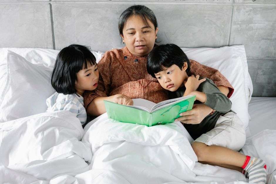 A grandmother telling stories to children gathered close around her