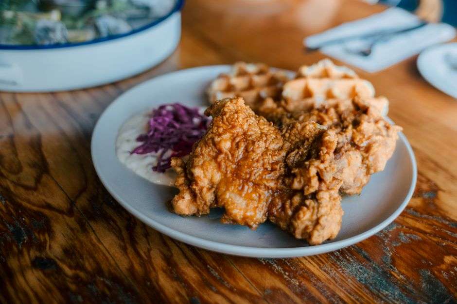 Plate of Southern comfort food with sides at a small-town café table