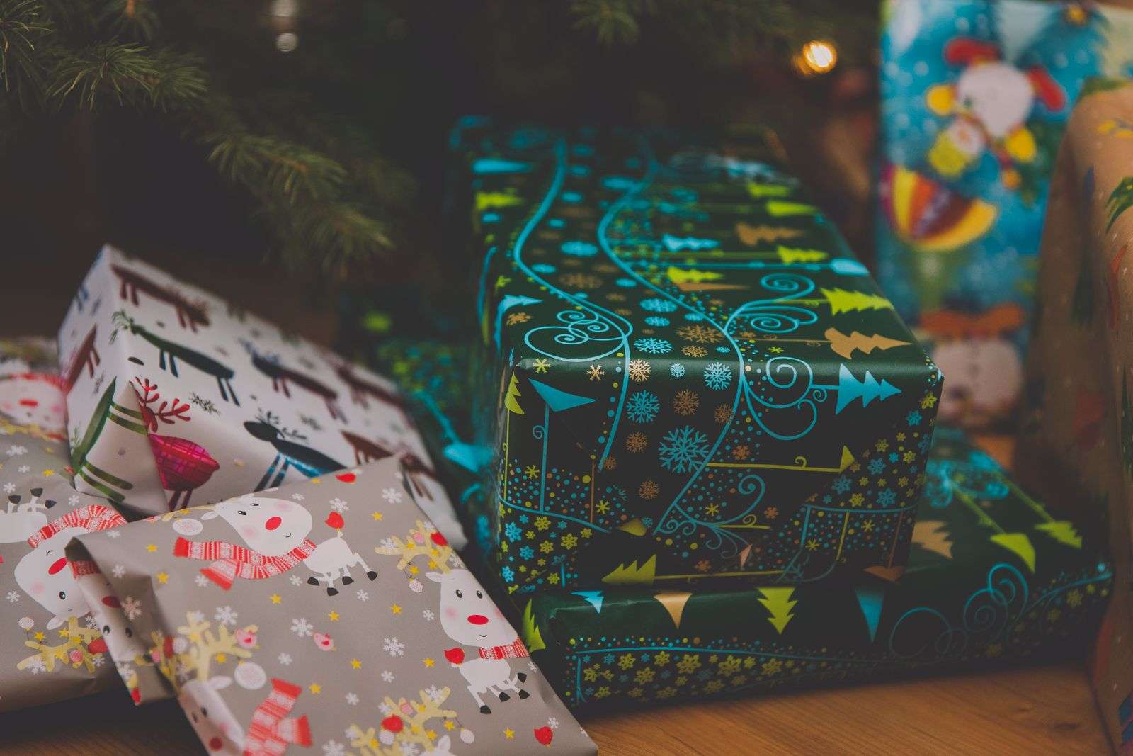 Wrapped Christmas presents beneath a decorated tree