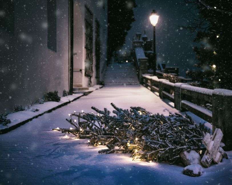 Small-town main street decorated with glowing Christmas lights in the evening