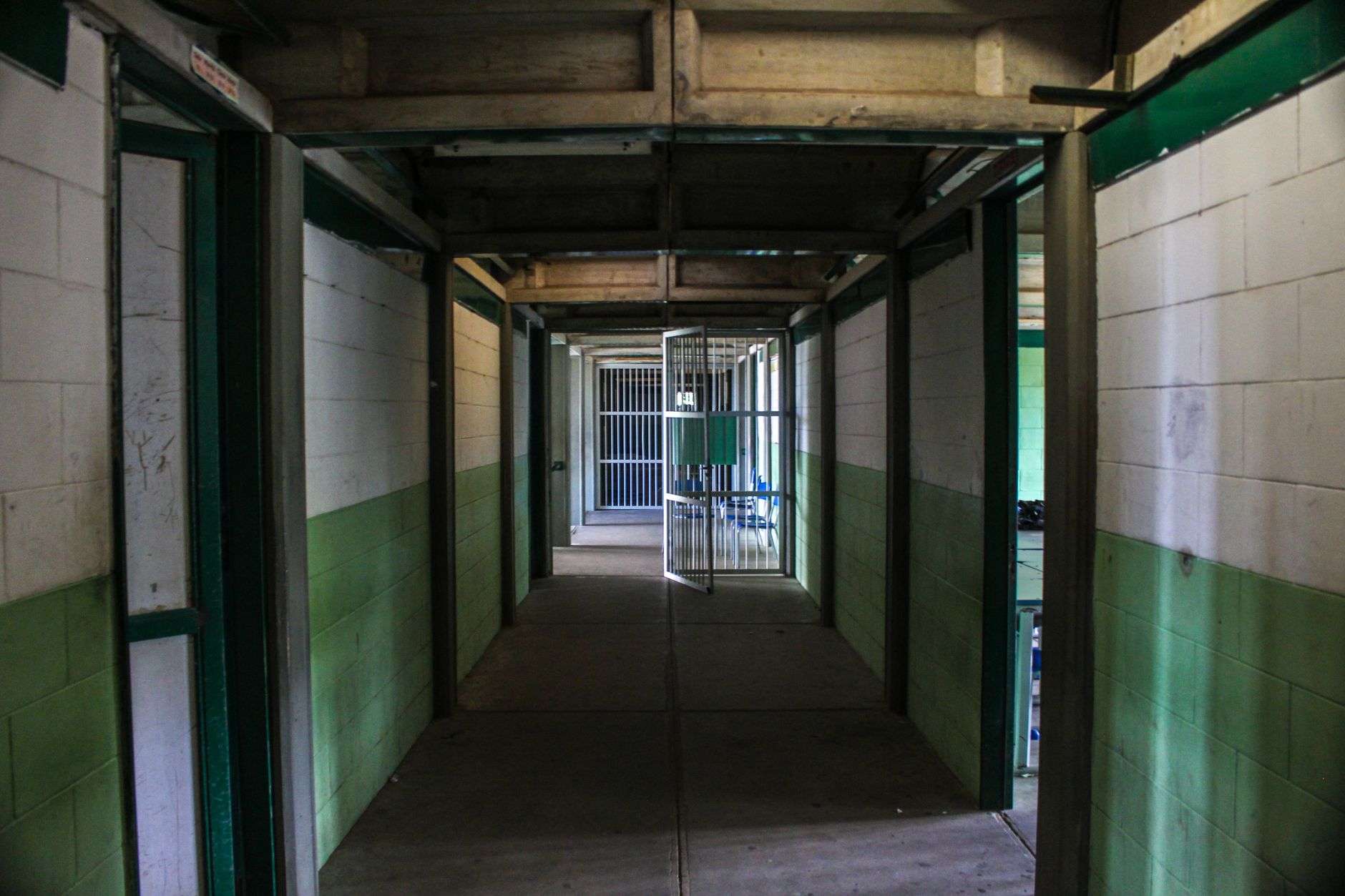A corridor of cells inside a detention facility