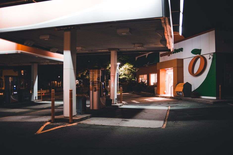 A gas station forecourt illuminated at night