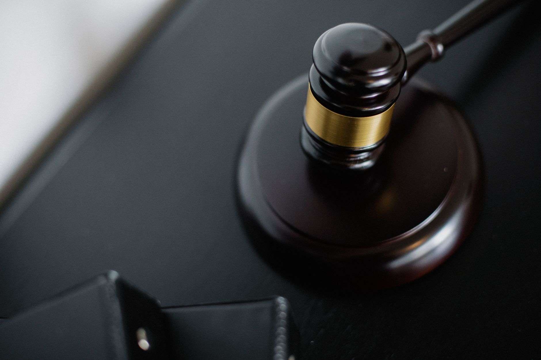 Wooden judges gavel resting on a sound block