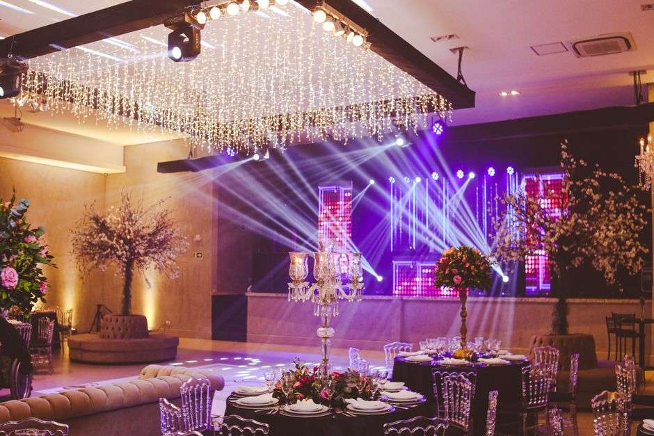 An elegant event venue with banquet tables and warm lighting