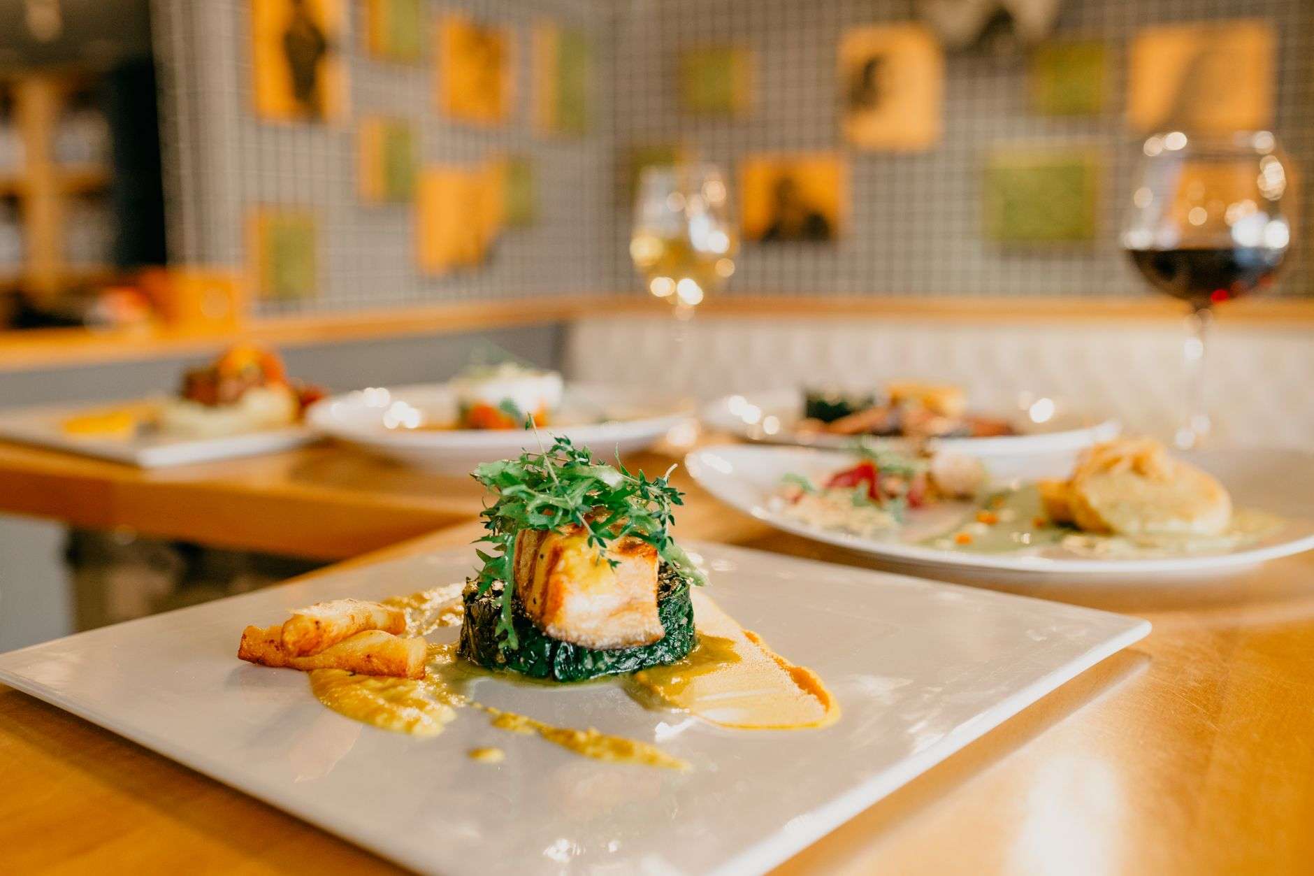 Plated dish on a restaurant table with place settings