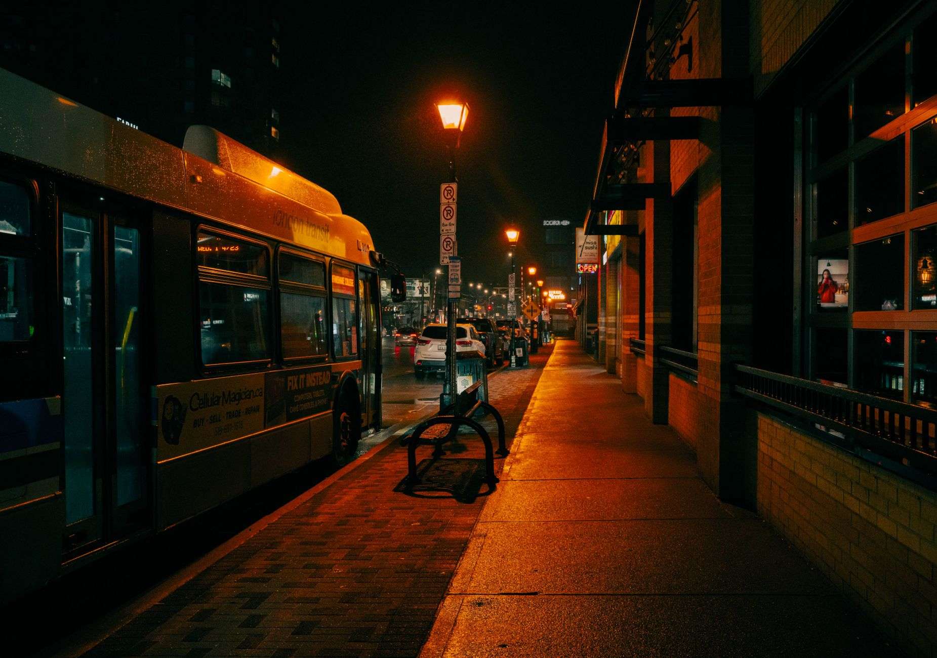 A quiet downtown city street with sidewalks and storefronts, illustrating the setting of a street robbery investigation