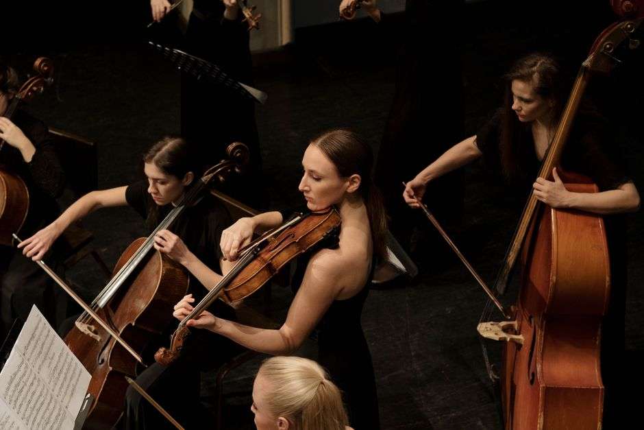 Violin and cello players performing chamber music together