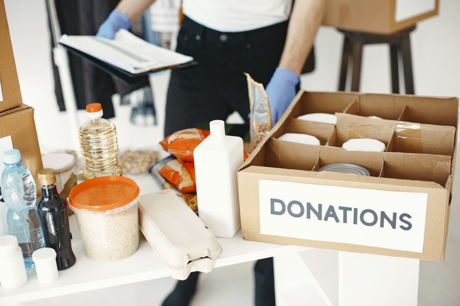 Volunteers organizing food donations at a community pantry