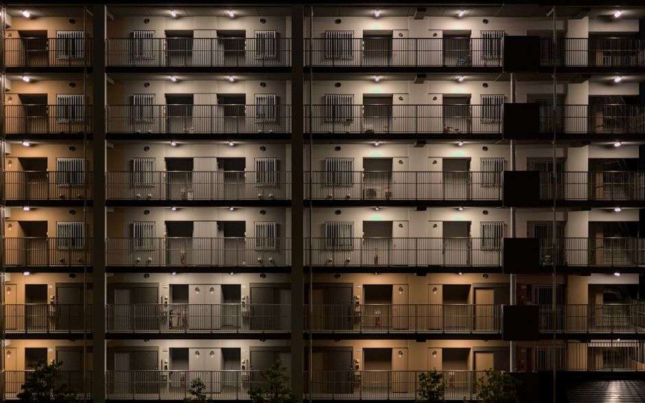 Apartment buildings at dusk with lights on