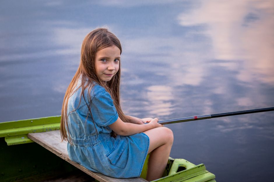 Children fish from a pier during a youth fishing tournament