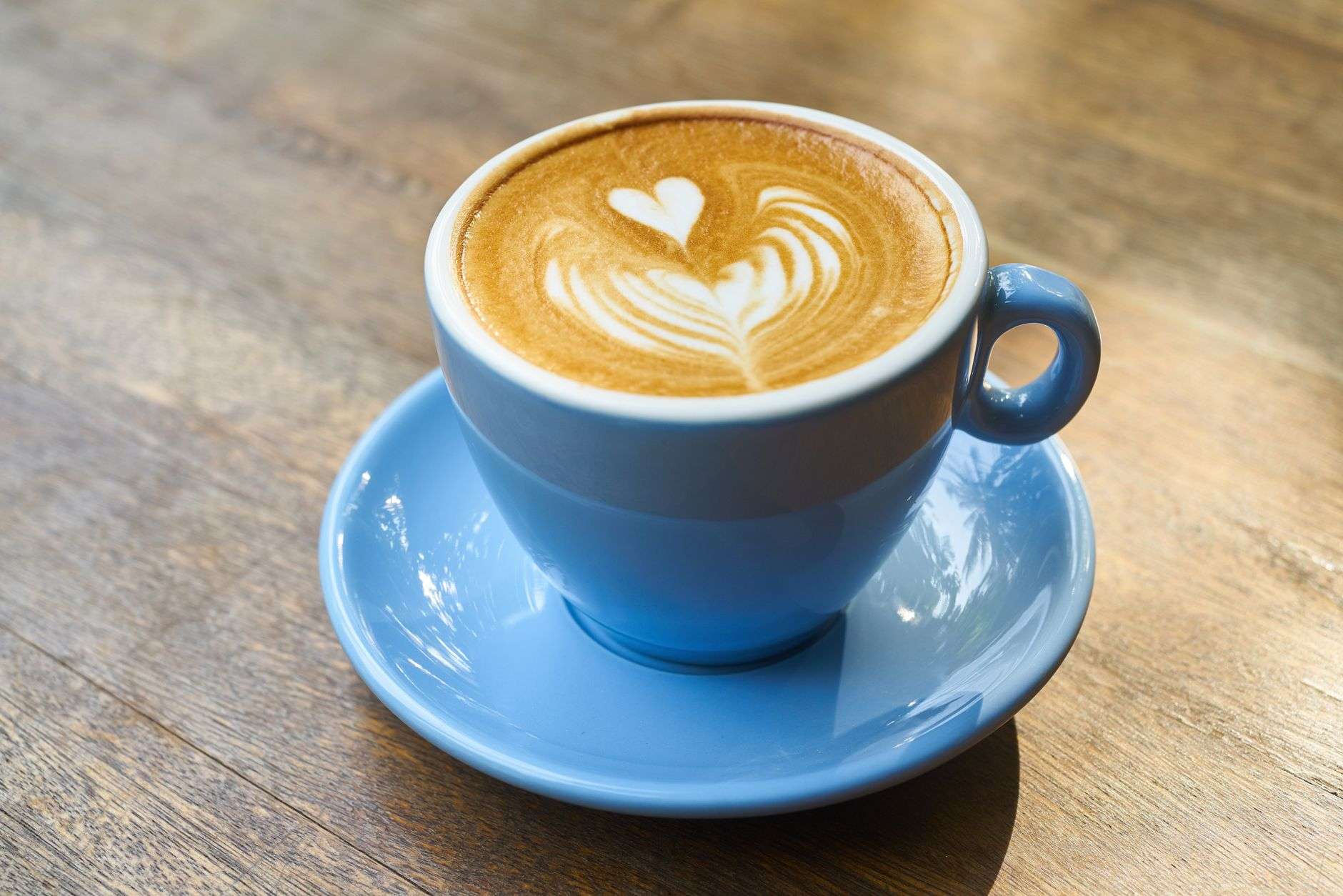 Two cups of coffee on a wooden table