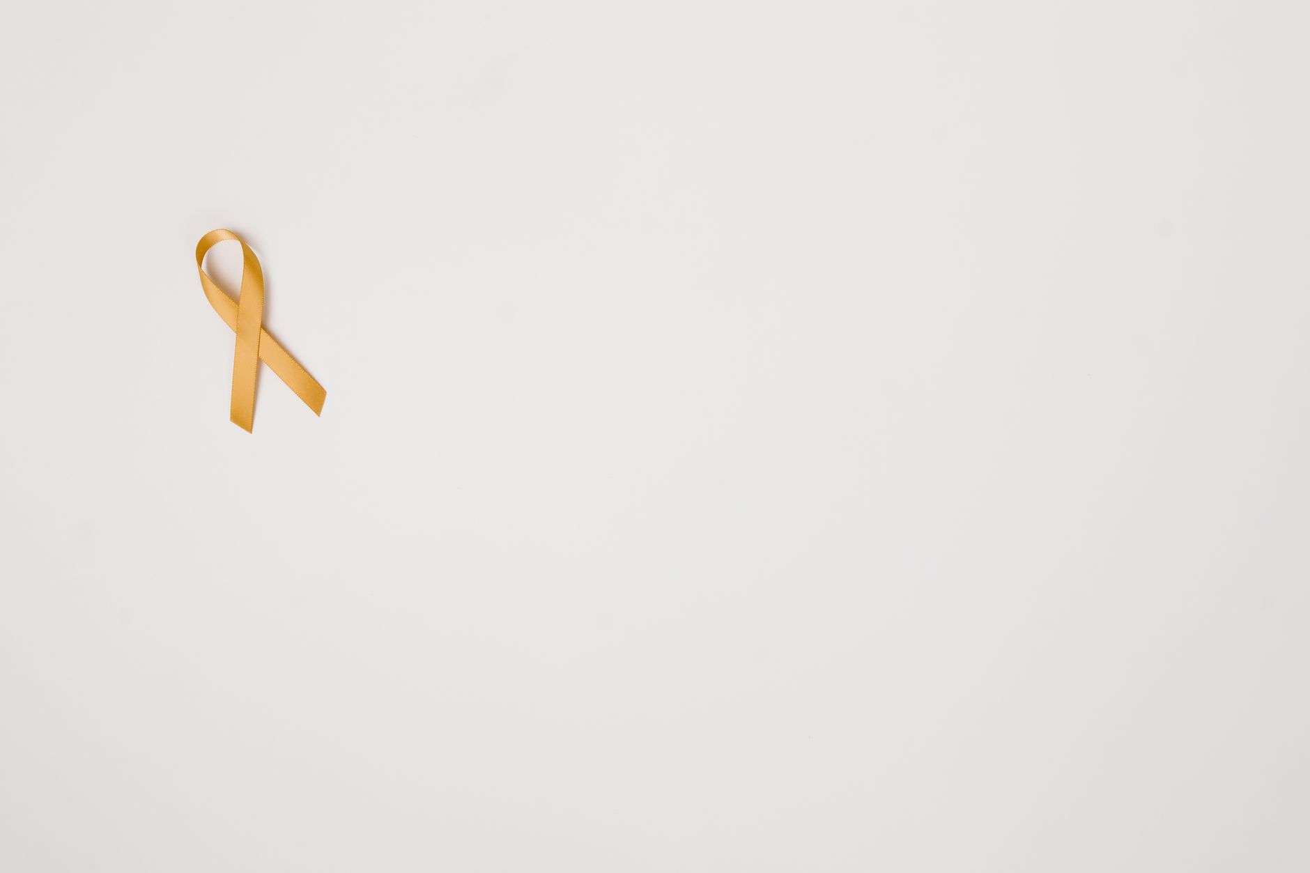 A bouquet of flowers with a gold ribbon