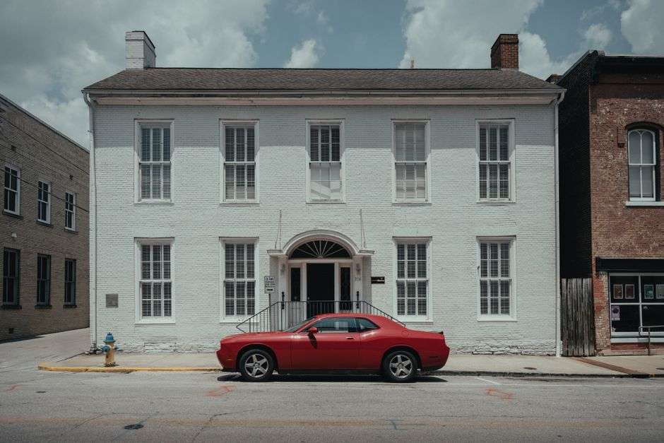 A charming small-town downtown street with storefronts and trees
