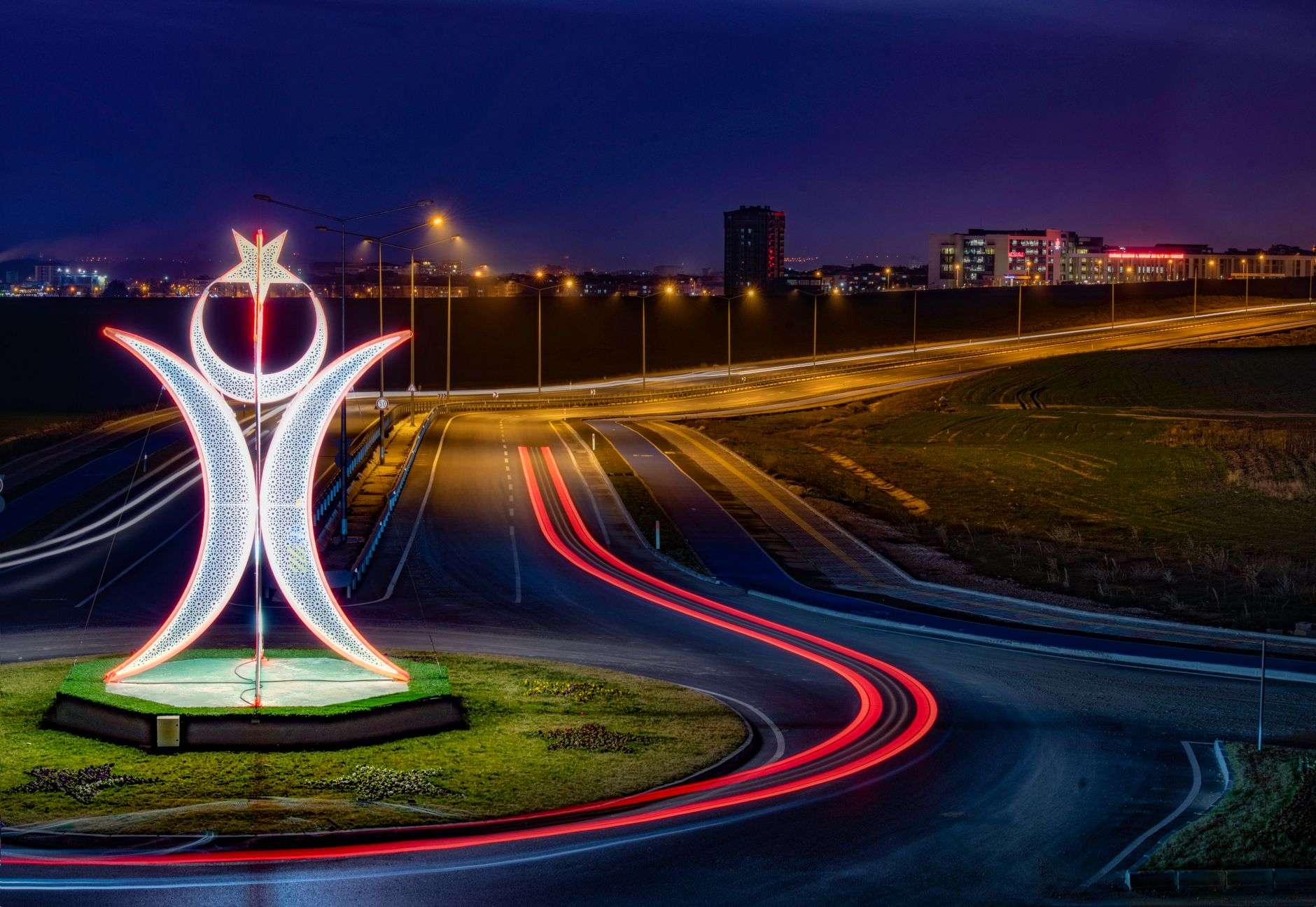 Outdoor public sculpture at a road intersection