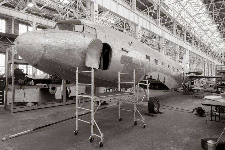 Commercial aircraft under assembly inside a manufacturing hangar