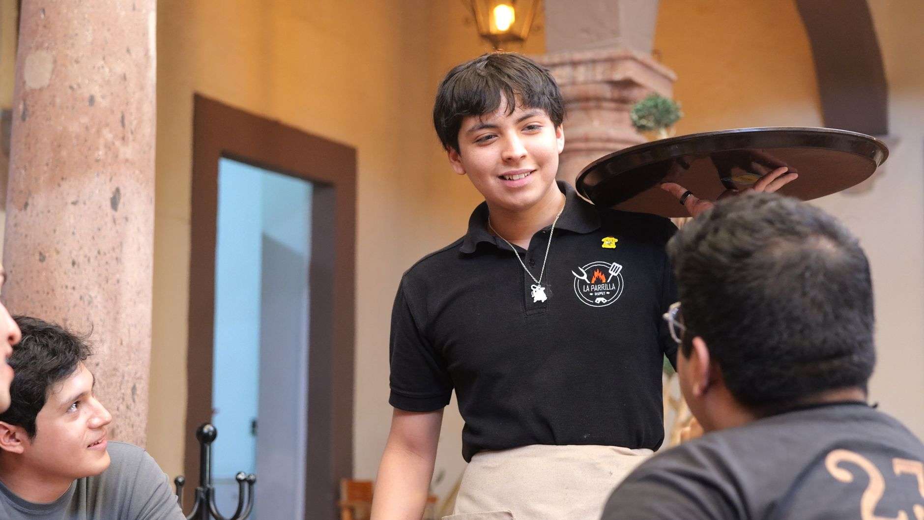 A server carrying plates in a restaurant
