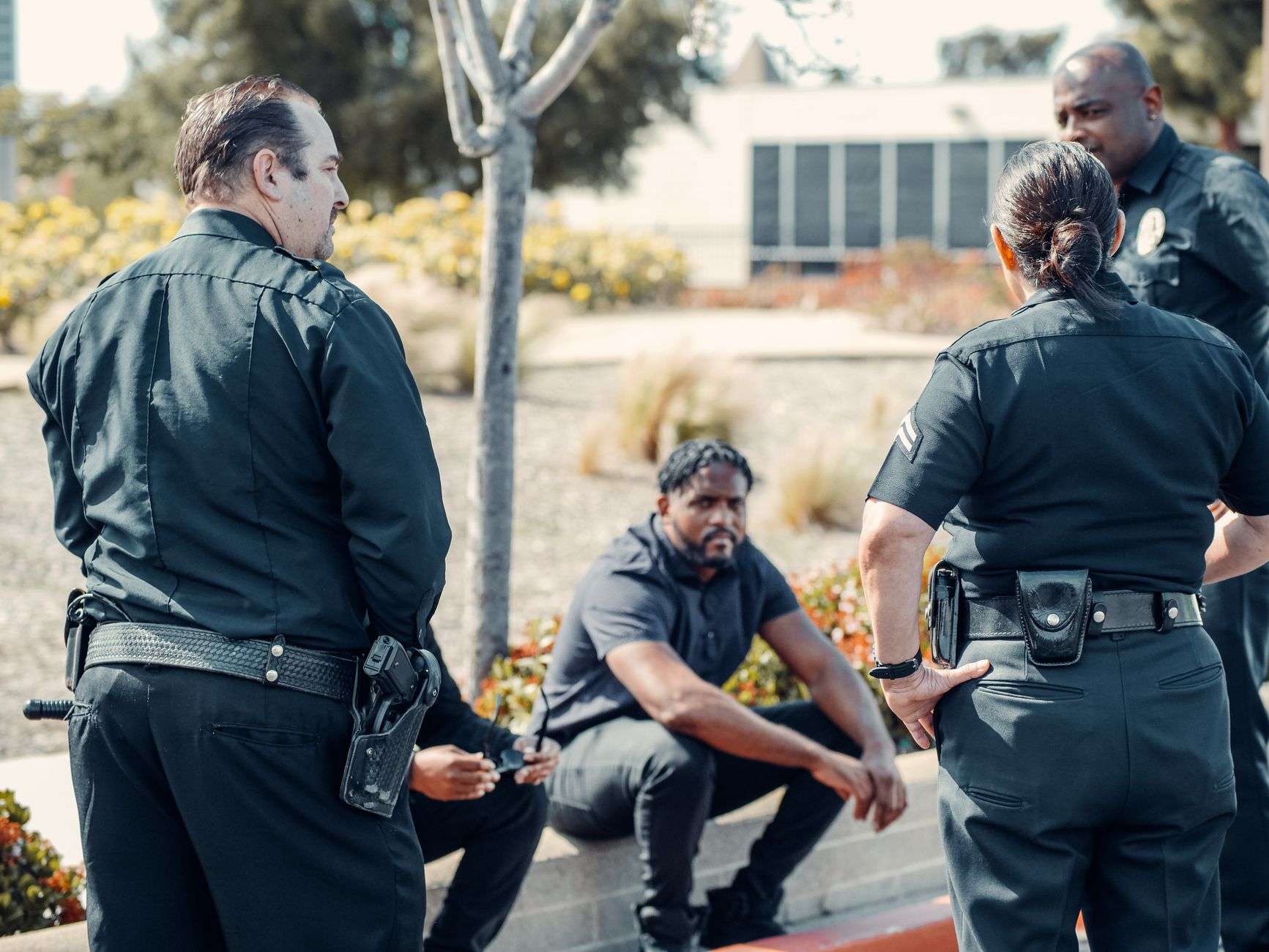 A police officer speaking with community members in a training setting