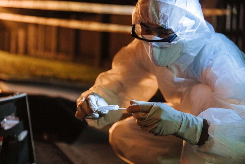 A law enforcement investigator examining computer equipment during a forensic review