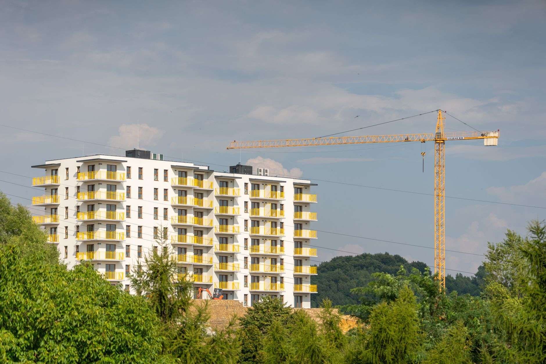 Multifamily apartment buildings under construction on a cleared site