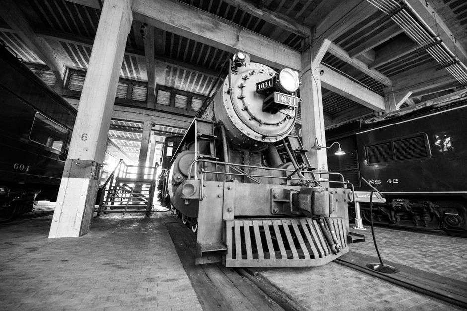 Historic wooden railroad depot museum building beside the tracks