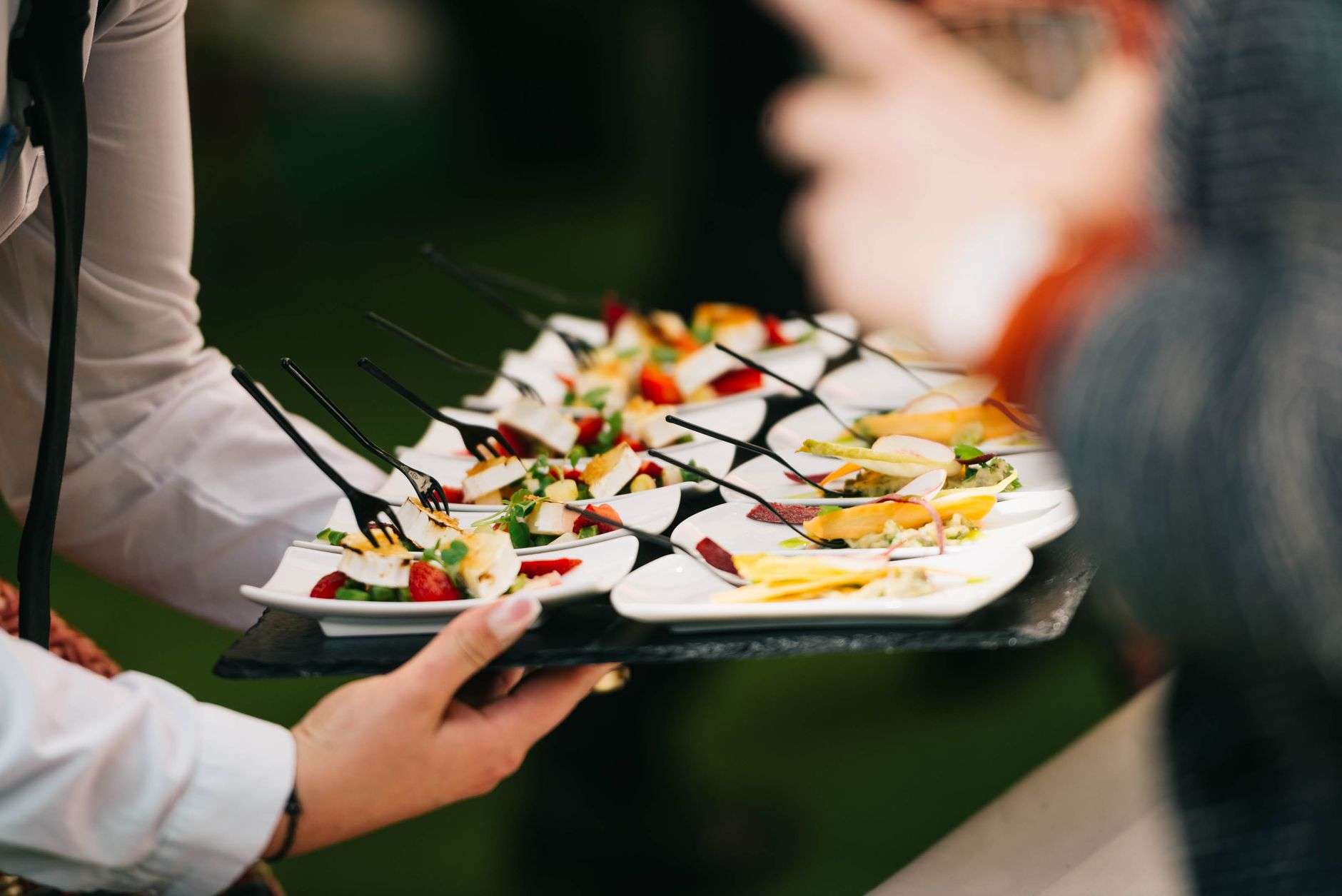 Food tasting stations set up at an indoor event