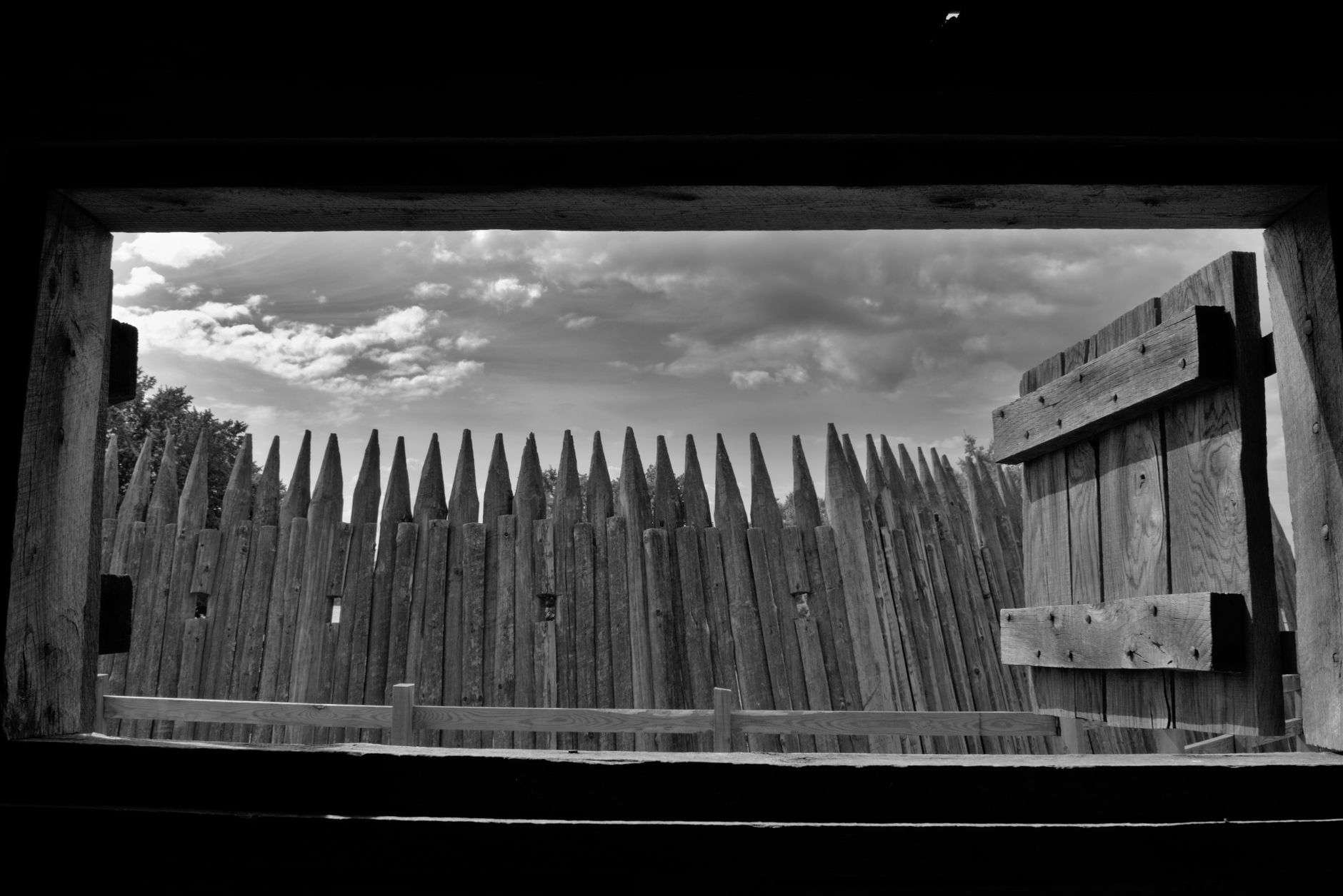 Pointed log palisade wall similar to a frontier stockade