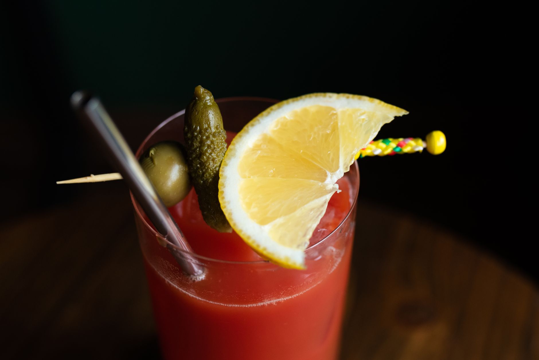 Bloody Mary cocktails garnished with celery and olives on a restaurant bar