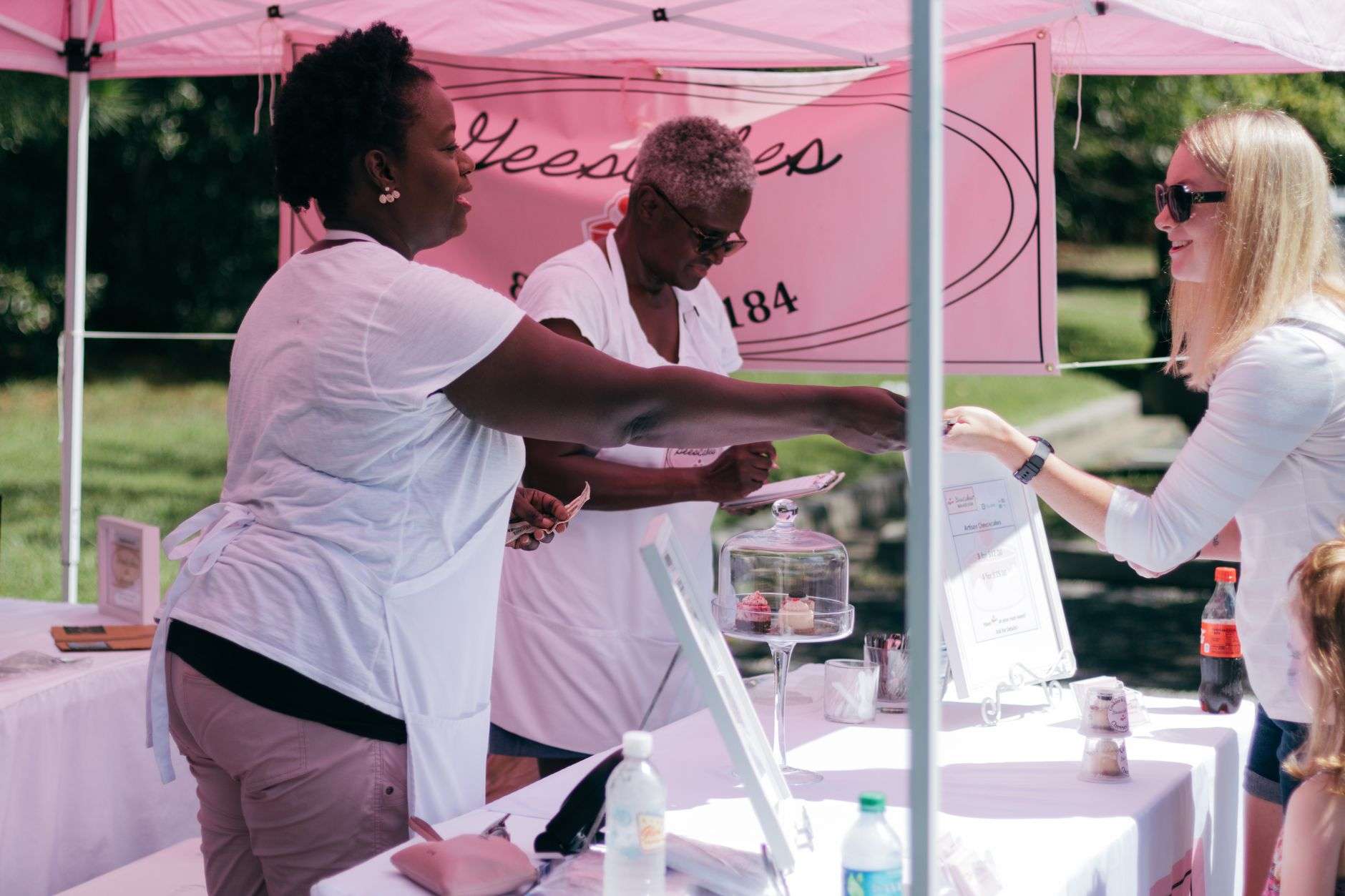 Volunteers at information tables illustrating the Sea Glass Initiative Community Resource Fair in Foley