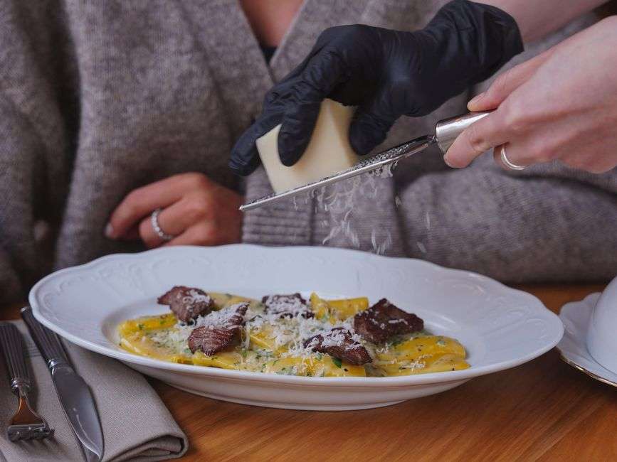 Plate of handmade Italian pasta served at a restaurant table