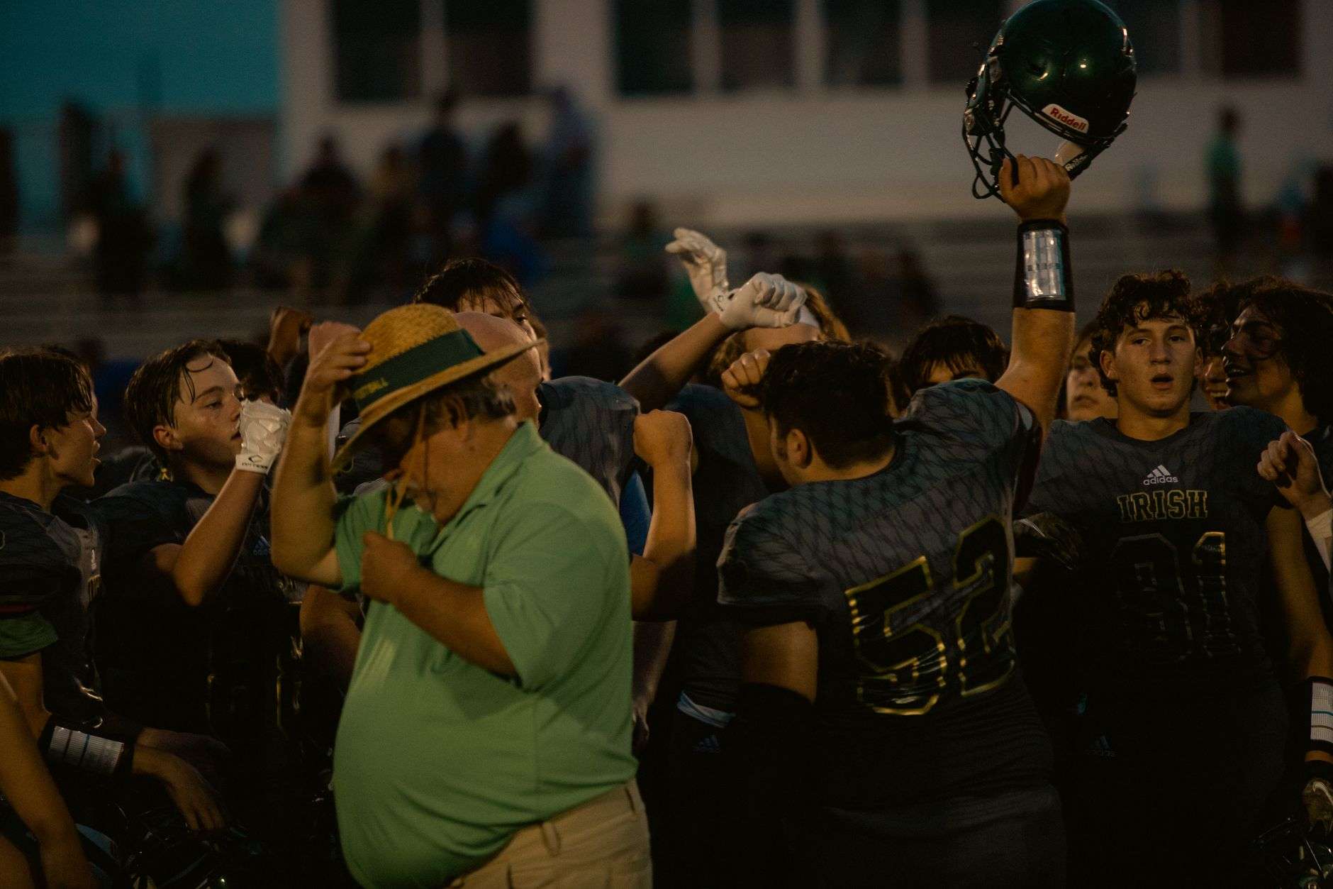 Football players lined up on a field during a night game