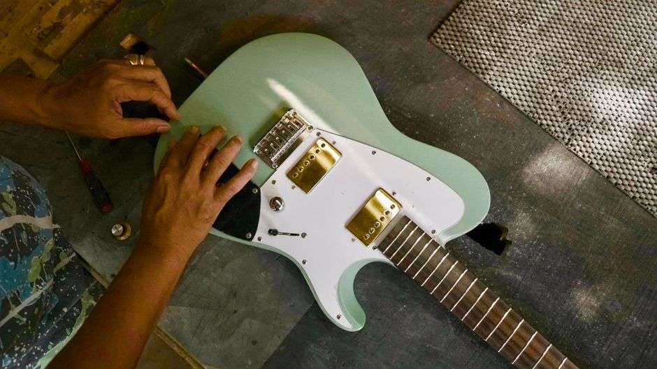 Luthier workbench with guitar bodies, tools and parts in a workshop