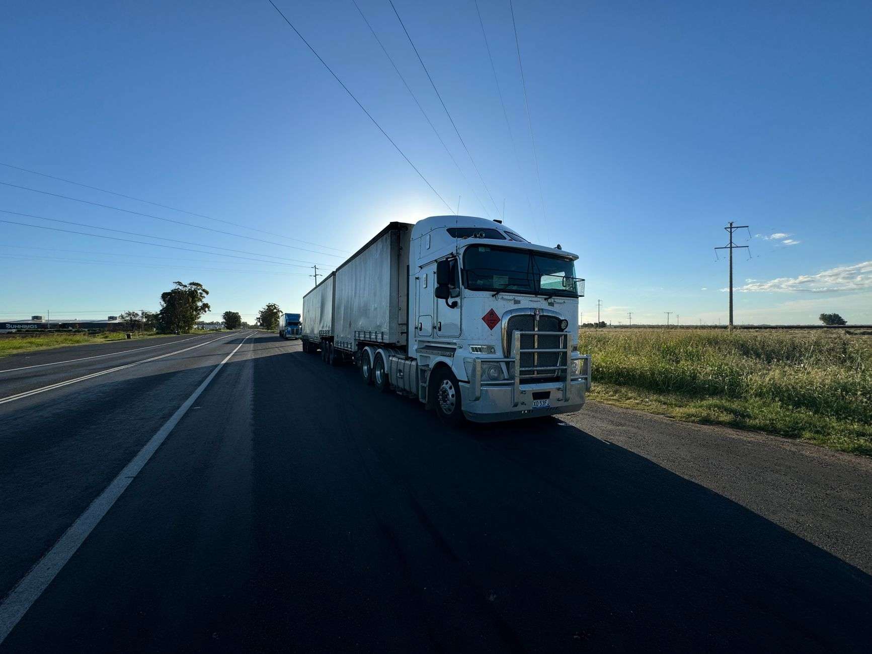 A semi truck traveling on a rural highway