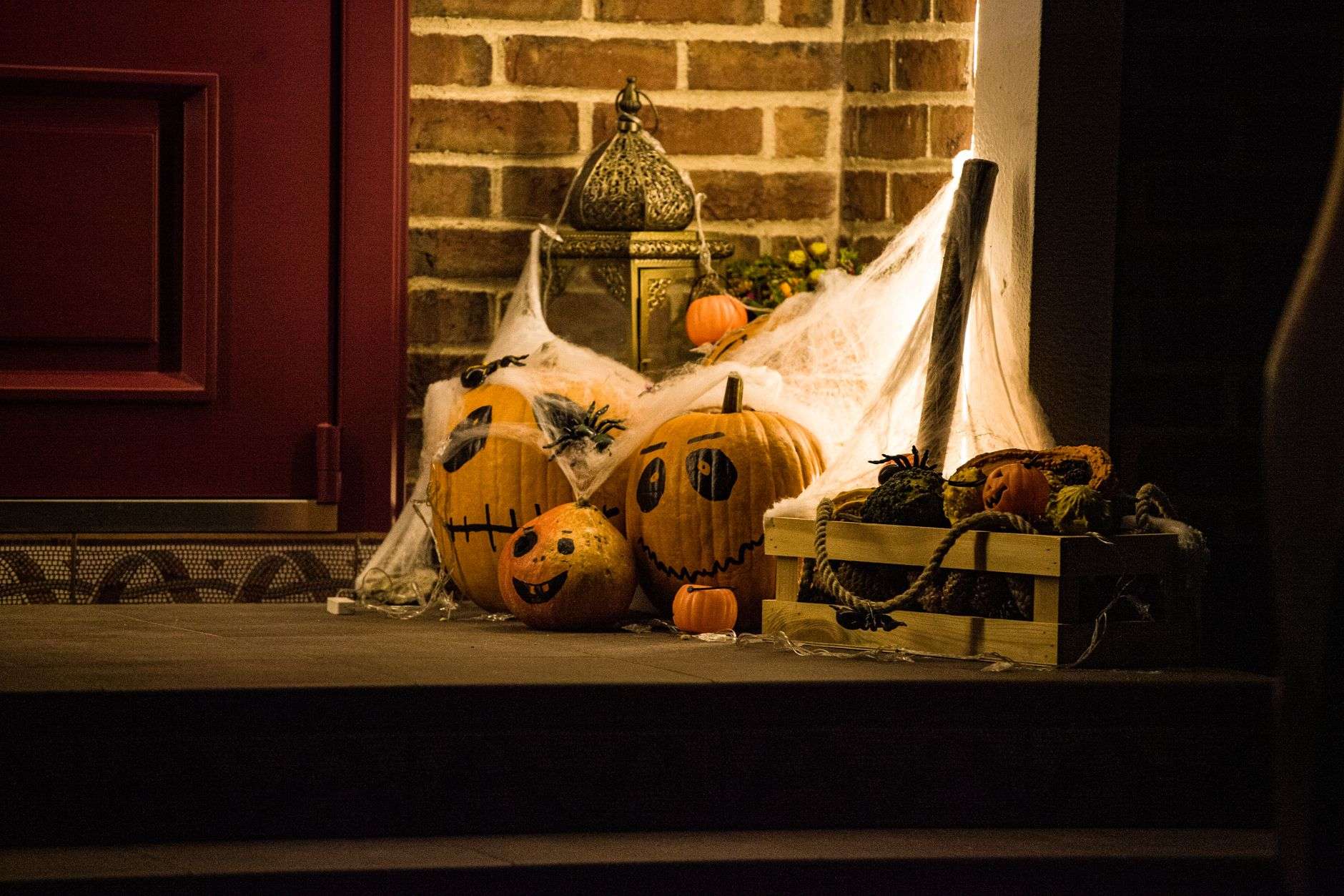 Halloween pumpkins and decorations on a residential front porch