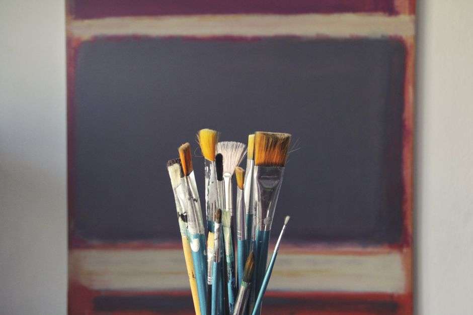 Painter working on a canvas in a bright art studio