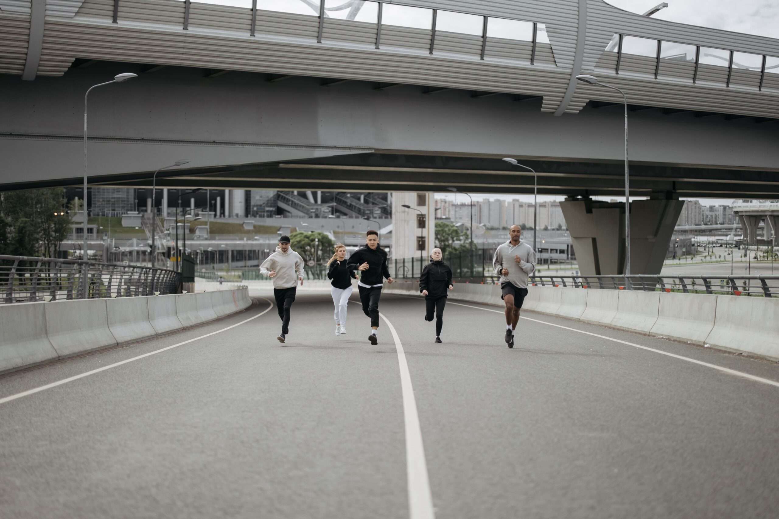 Group of people jogging together on a road