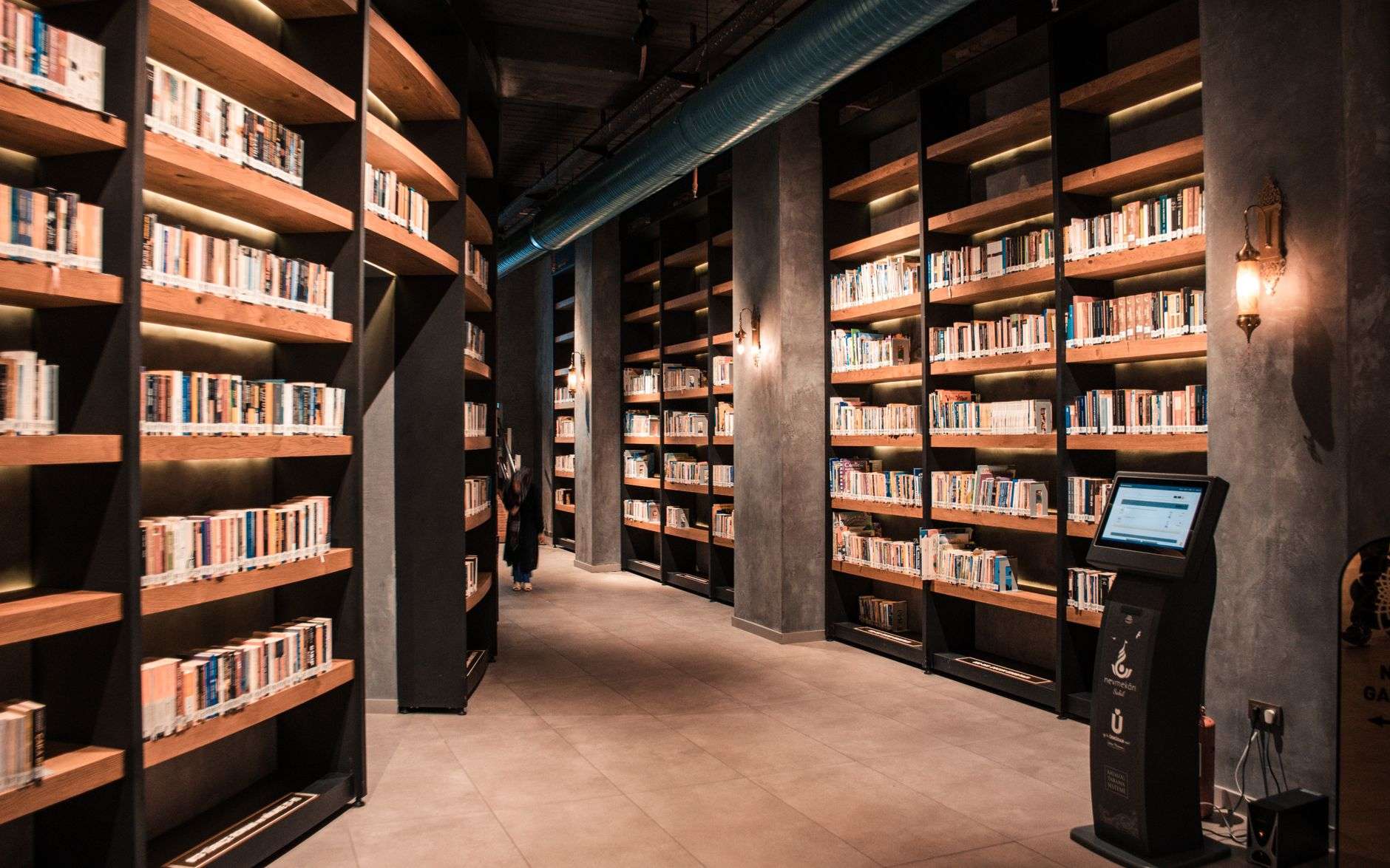 Rows of books on shelves inside a public library
